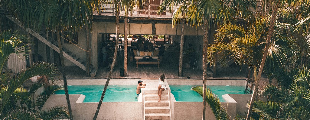 Couple enjoying a luxury villa vacation in Tulum with Beach Please